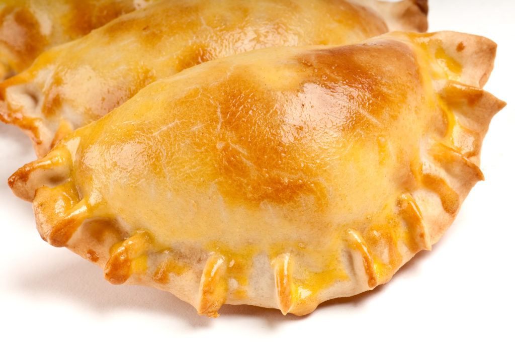 Group of Latin american empanadas. The Empanada is a pastry turnover filled with a variety of savory ingredients and baked or fried.